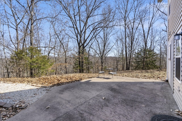 view of patio / terrace with a wooded view