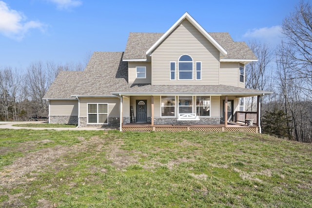 view of front of home with a porch, stone siding, roof with shingles, and a front lawn