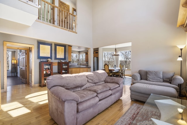 living room with baseboards and light wood-style floors