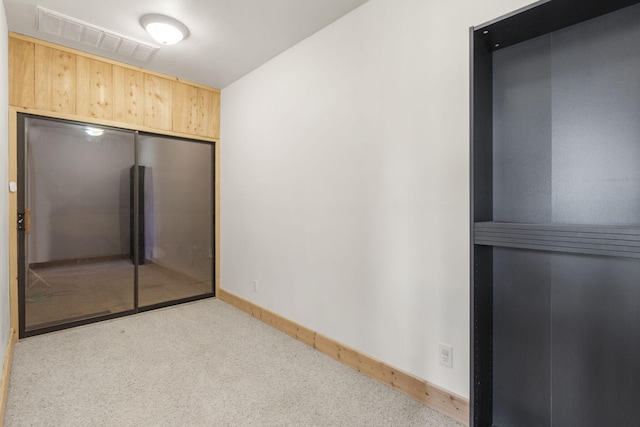 interior space featuring visible vents, baseboards, and wooden walls