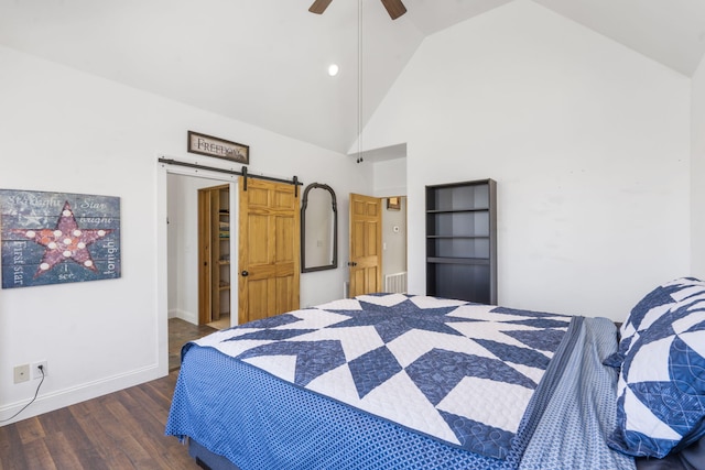 bedroom featuring baseboards, a barn door, wood finished floors, high vaulted ceiling, and a ceiling fan