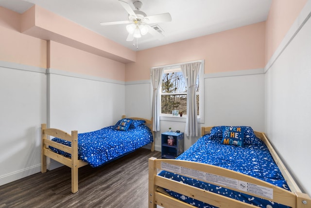 bedroom featuring wood finished floors, visible vents, and ceiling fan