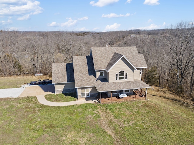 birds eye view of property with a wooded view