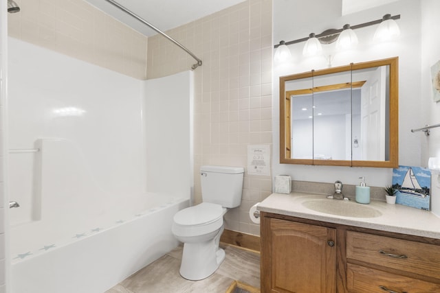 bathroom featuring vanity, tile walls, toilet, and tub / shower combination