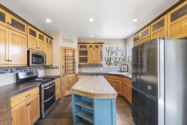 kitchen with wooden counters, open shelves, appliances with stainless steel finishes, tasteful backsplash, and a center island