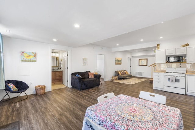 living area with visible vents, recessed lighting, dark wood-type flooring, and baseboards