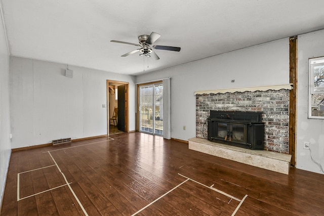 unfurnished living room with visible vents, a ceiling fan, hardwood / wood-style floors, a glass covered fireplace, and baseboards