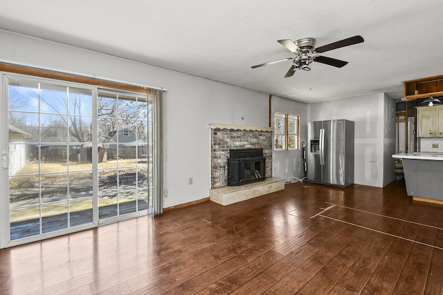 unfurnished living room with dark wood finished floors and ceiling fan