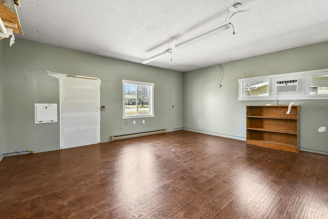 interior space with an AC wall unit and a baseboard radiator