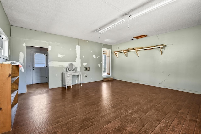 interior space with wood finished floors and a textured ceiling