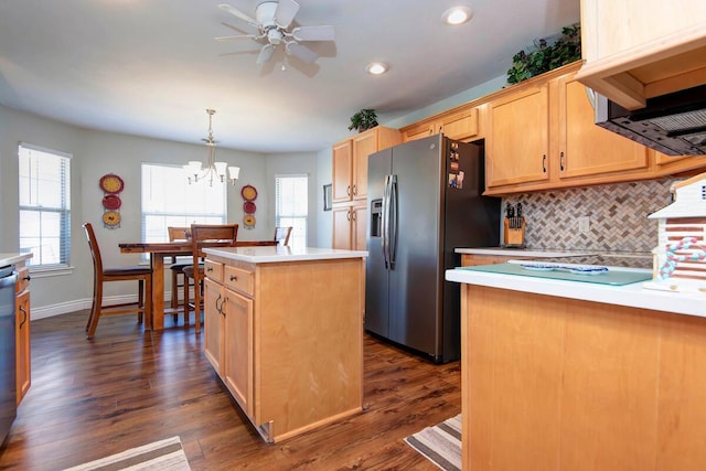 kitchen with a center island, dark wood finished floors, light countertops, decorative backsplash, and appliances with stainless steel finishes