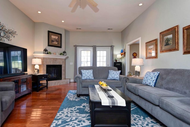 living room with wood finished floors, visible vents, recessed lighting, ceiling fan, and a tile fireplace