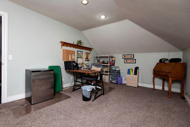 carpeted office space featuring baseboards and vaulted ceiling