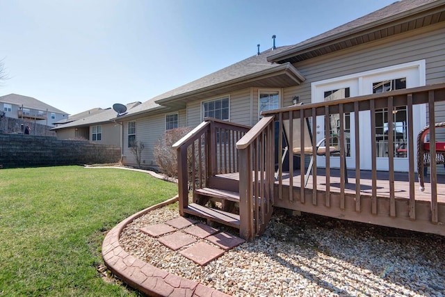 wooden terrace with a yard and fence