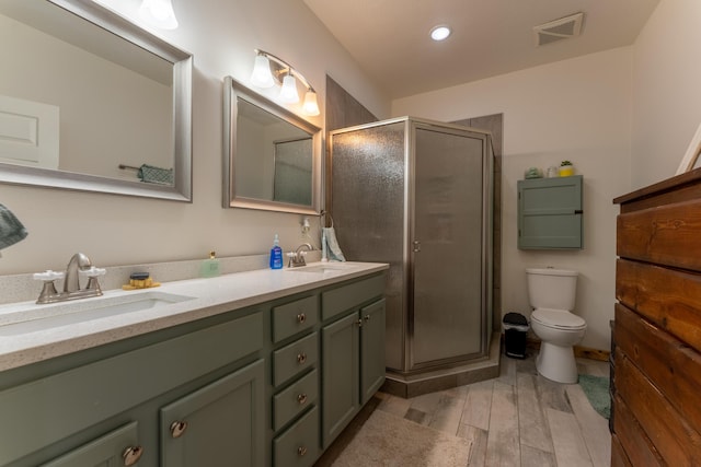 full bathroom with double vanity, visible vents, a stall shower, and a sink