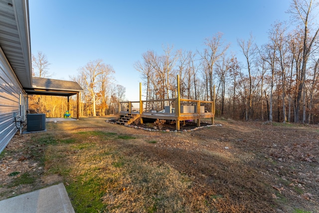 view of yard with a deck and central AC unit