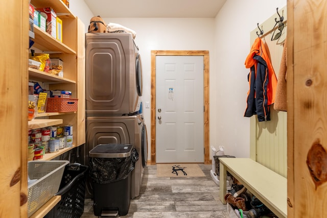 washroom with laundry area, stacked washing maching and dryer, and wood finished floors