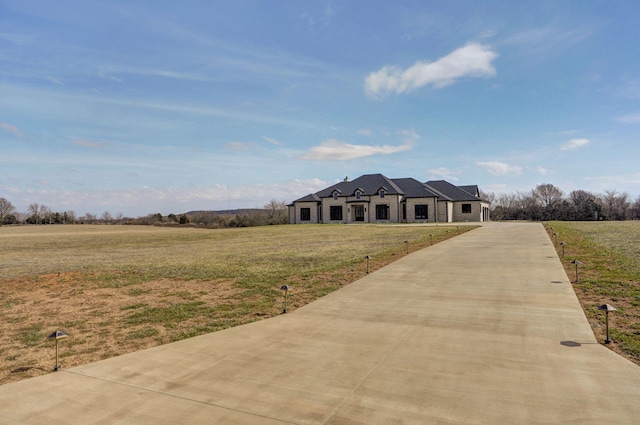 view of front facade with a front lawn and driveway