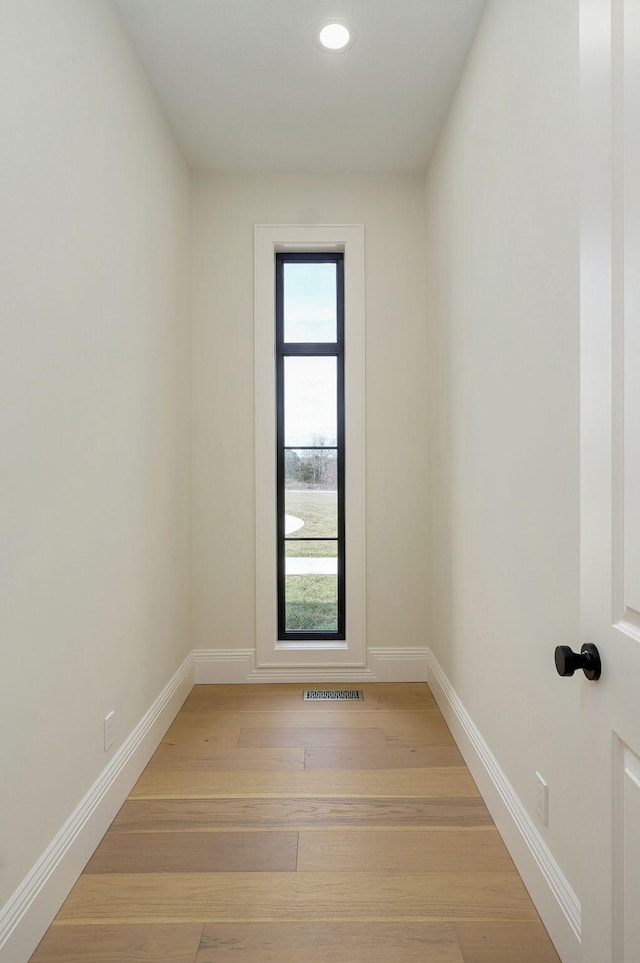 empty room featuring recessed lighting, visible vents, baseboards, and light wood finished floors