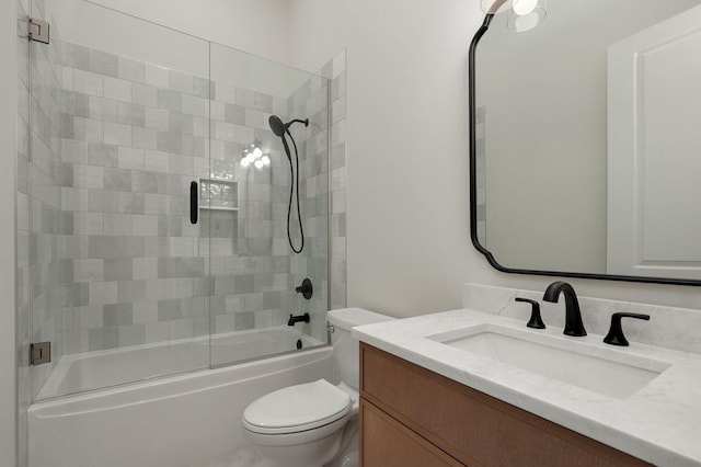 bathroom with shower / bath combination with glass door, toilet, and vanity