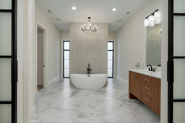 bathroom featuring visible vents, baseboards, a freestanding tub, marble finish floor, and vanity