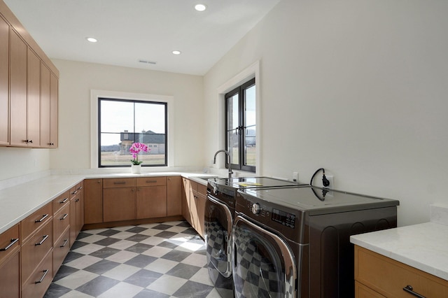 laundry area with light floors, visible vents, cabinet space, recessed lighting, and washer and dryer