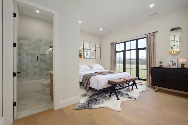 bedroom with visible vents, baseboards, light wood-type flooring, recessed lighting, and ensuite bathroom