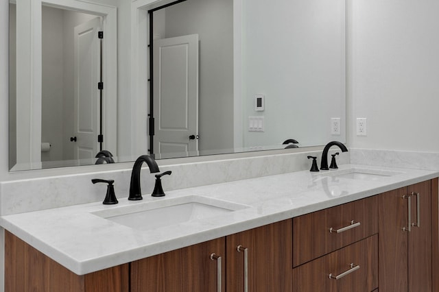 bathroom featuring double vanity and a sink