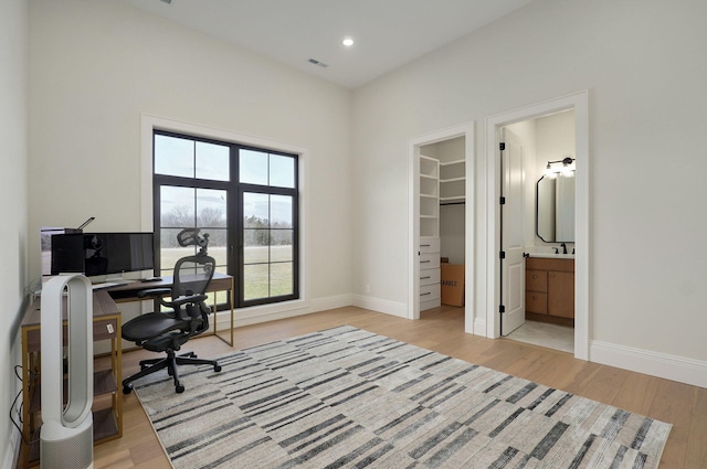 office space featuring visible vents, recessed lighting, baseboards, and light wood-type flooring