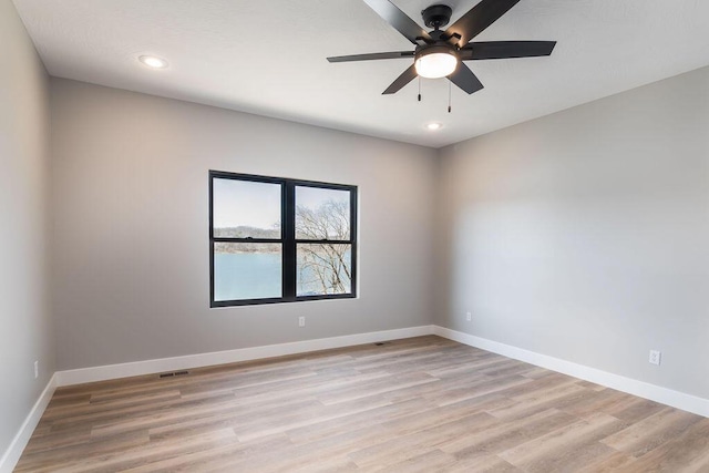 unfurnished room featuring recessed lighting, light wood-type flooring, baseboards, and a ceiling fan