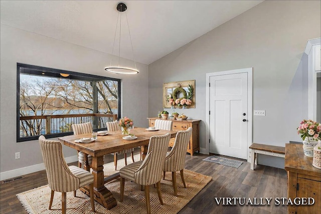 dining area with dark wood-type flooring, baseboards, visible vents, and high vaulted ceiling