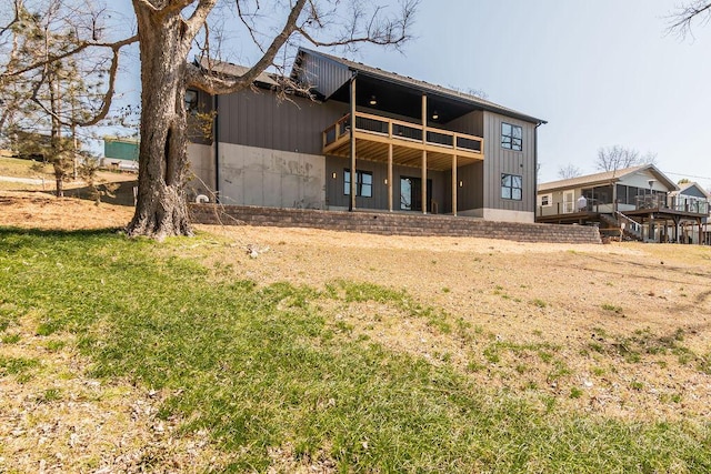 rear view of property featuring board and batten siding