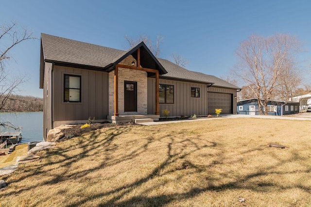 view of front of house with driveway, a front lawn, board and batten siding, a shingled roof, and a garage