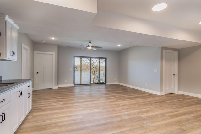 interior space with recessed lighting, baseboards, light wood-style floors, and ceiling fan