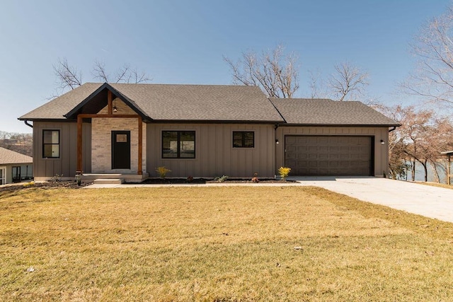 view of front of property featuring a front yard, an attached garage, board and batten siding, and driveway