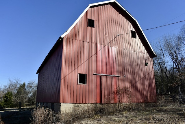 view of home's exterior featuring an outbuilding, a gambrel roof, and a barn