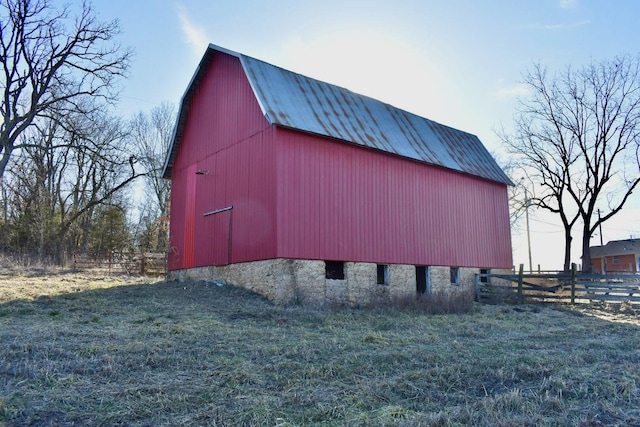 view of barn featuring fence