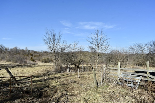 view of yard with a rural view and fence