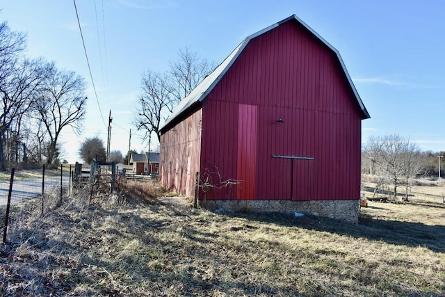 view of barn with fence