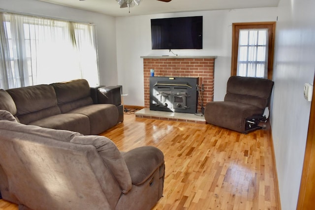 living area with wood finished floors and a ceiling fan