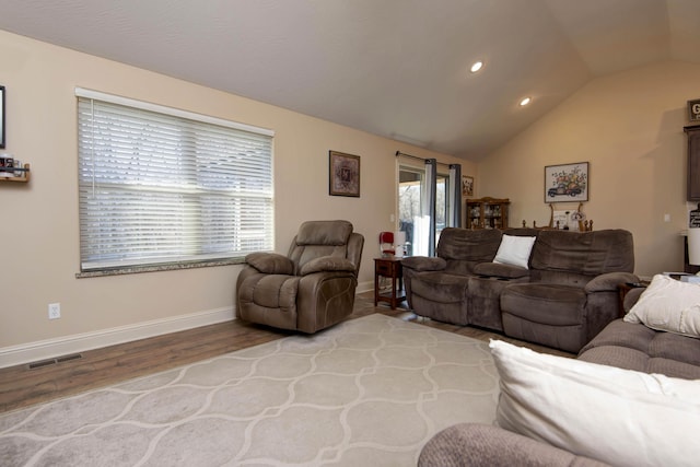 living room with visible vents, wood finished floors, recessed lighting, baseboards, and lofted ceiling