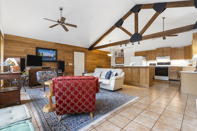 living area featuring a ceiling fan, high vaulted ceiling, light tile patterned flooring, wood walls, and beamed ceiling