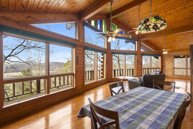 sunroom featuring wood ceiling, lofted ceiling with beams, and ceiling fan