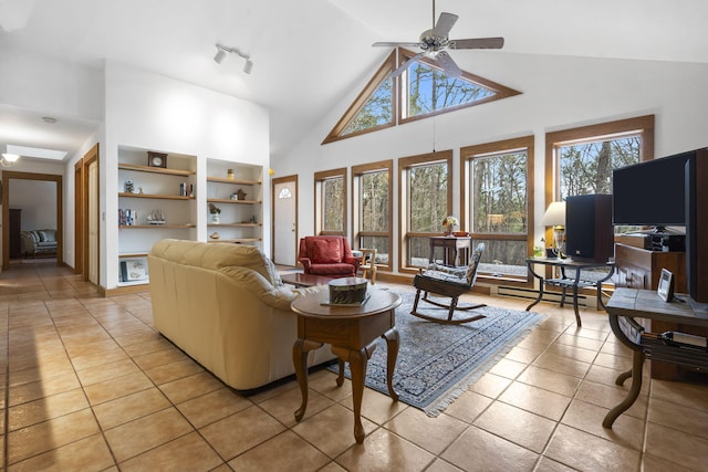 tiled living room with rail lighting, high vaulted ceiling, ceiling fan, and a baseboard radiator