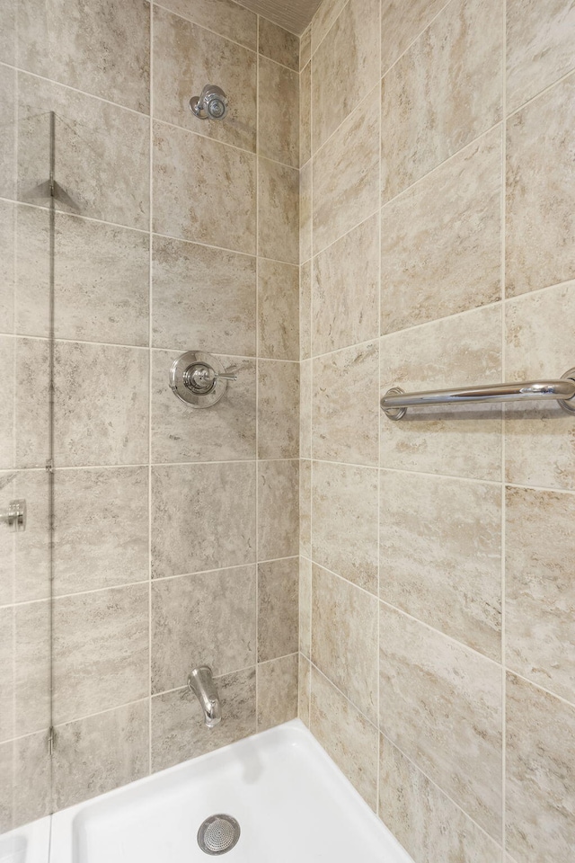 full bath with a tile shower