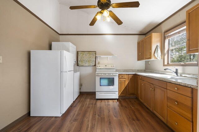 kitchen with a sink, white appliances, light countertops, dark wood-style flooring, and vaulted ceiling