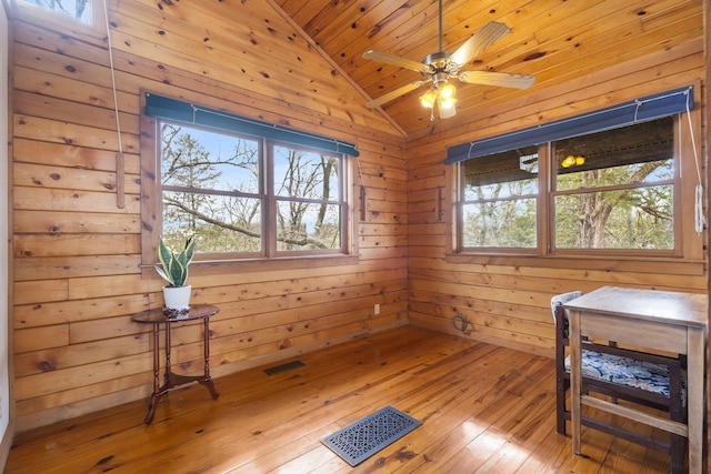 sitting room with visible vents, lofted ceiling, and a healthy amount of sunlight