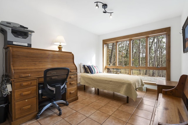 bedroom featuring light tile patterned floors and lofted ceiling