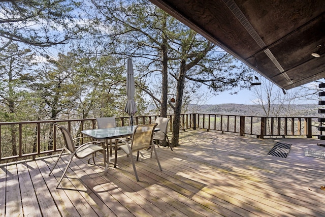 wooden terrace featuring outdoor dining area