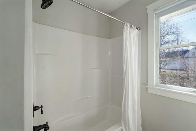 bathroom featuring curtained shower and a healthy amount of sunlight